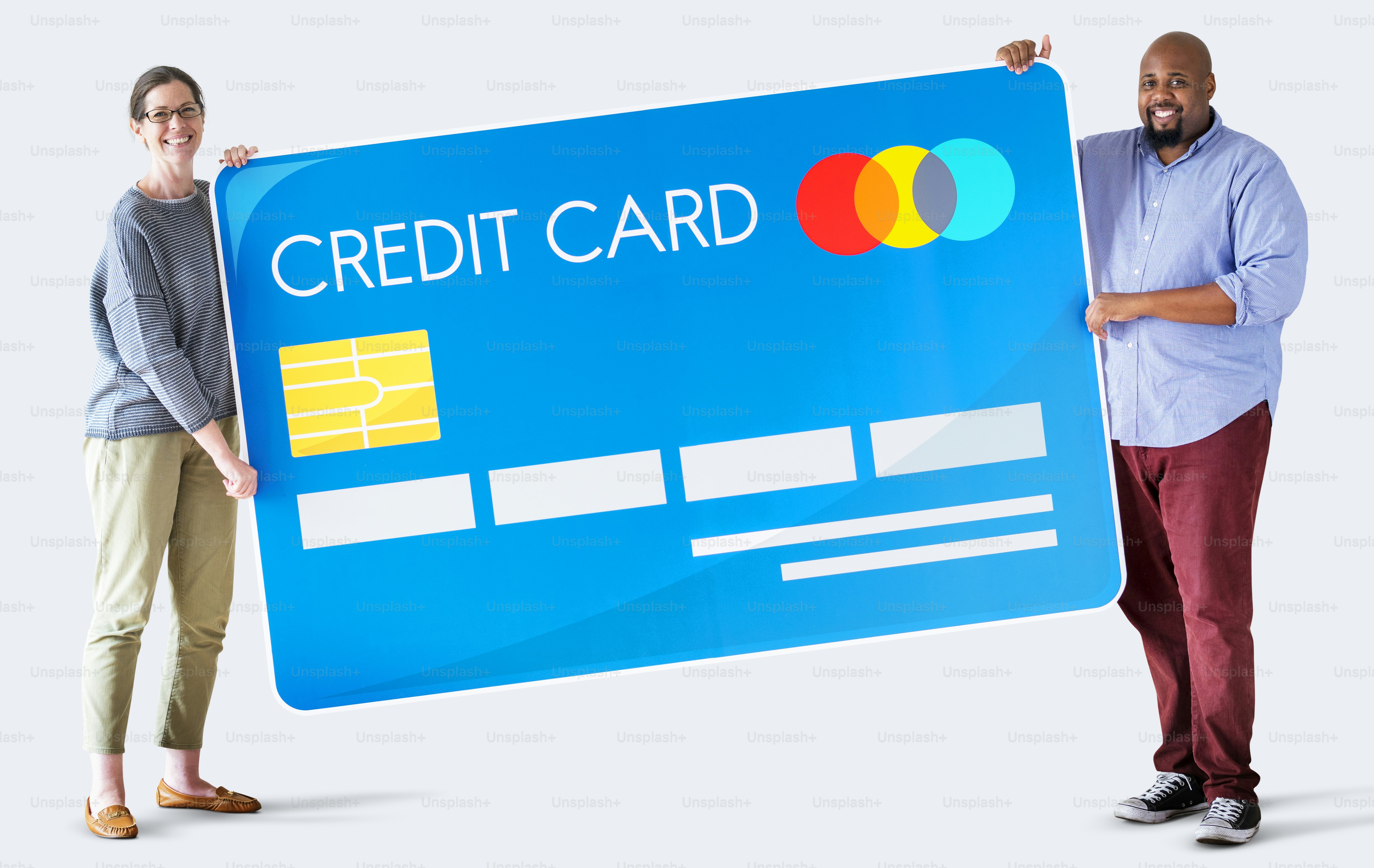 A woman and a man holding a large blue credit card sign